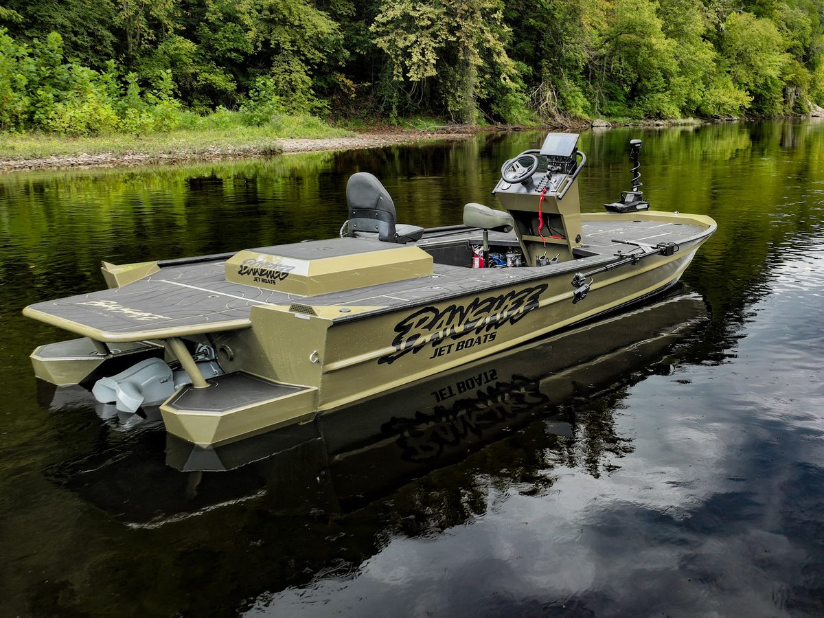 The SR 72 Inboard Jet seen from the stern, reflected in still river water