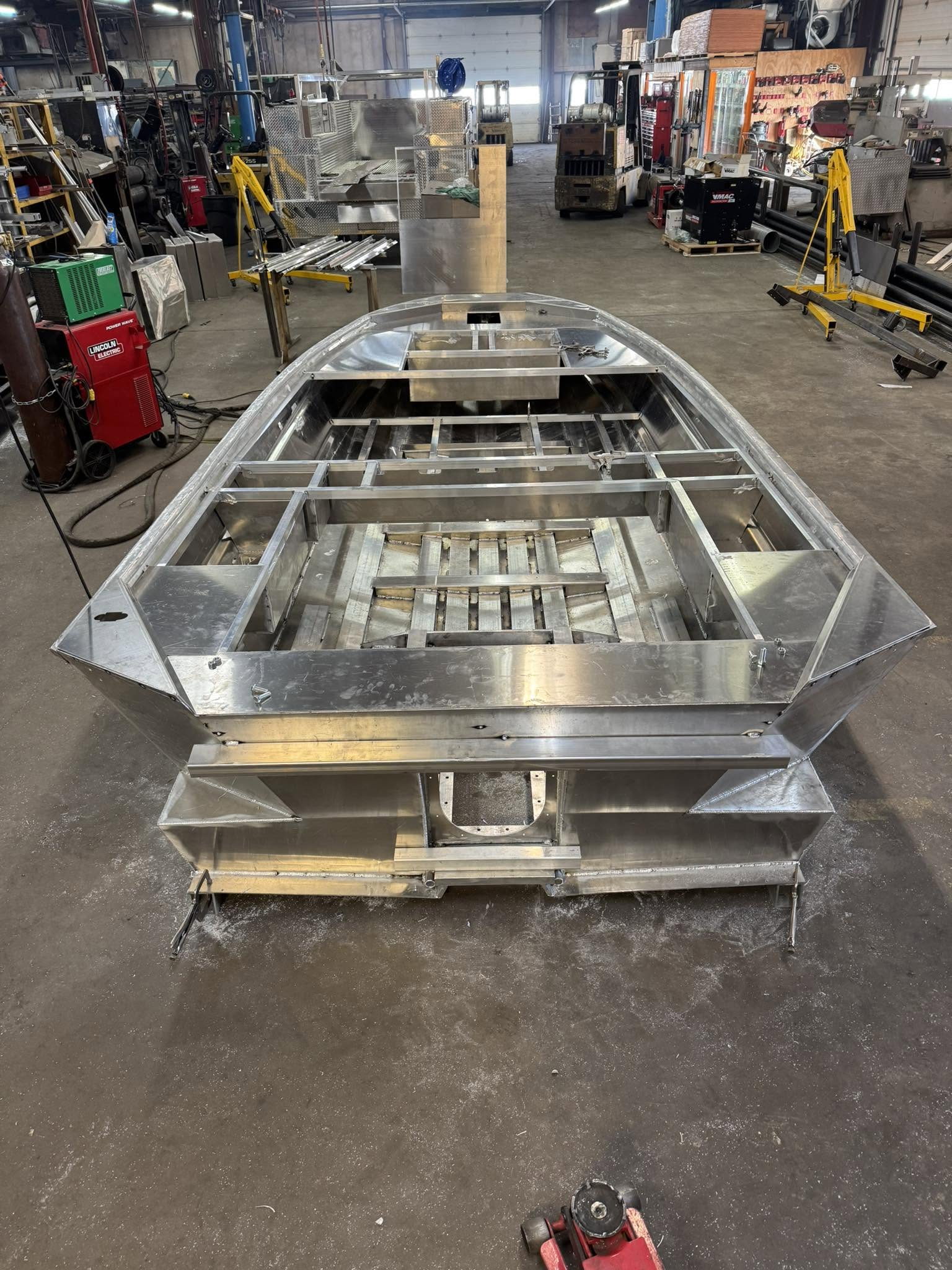 A Banshee hull under construction in the shop, stern on, showing the welded deck framing